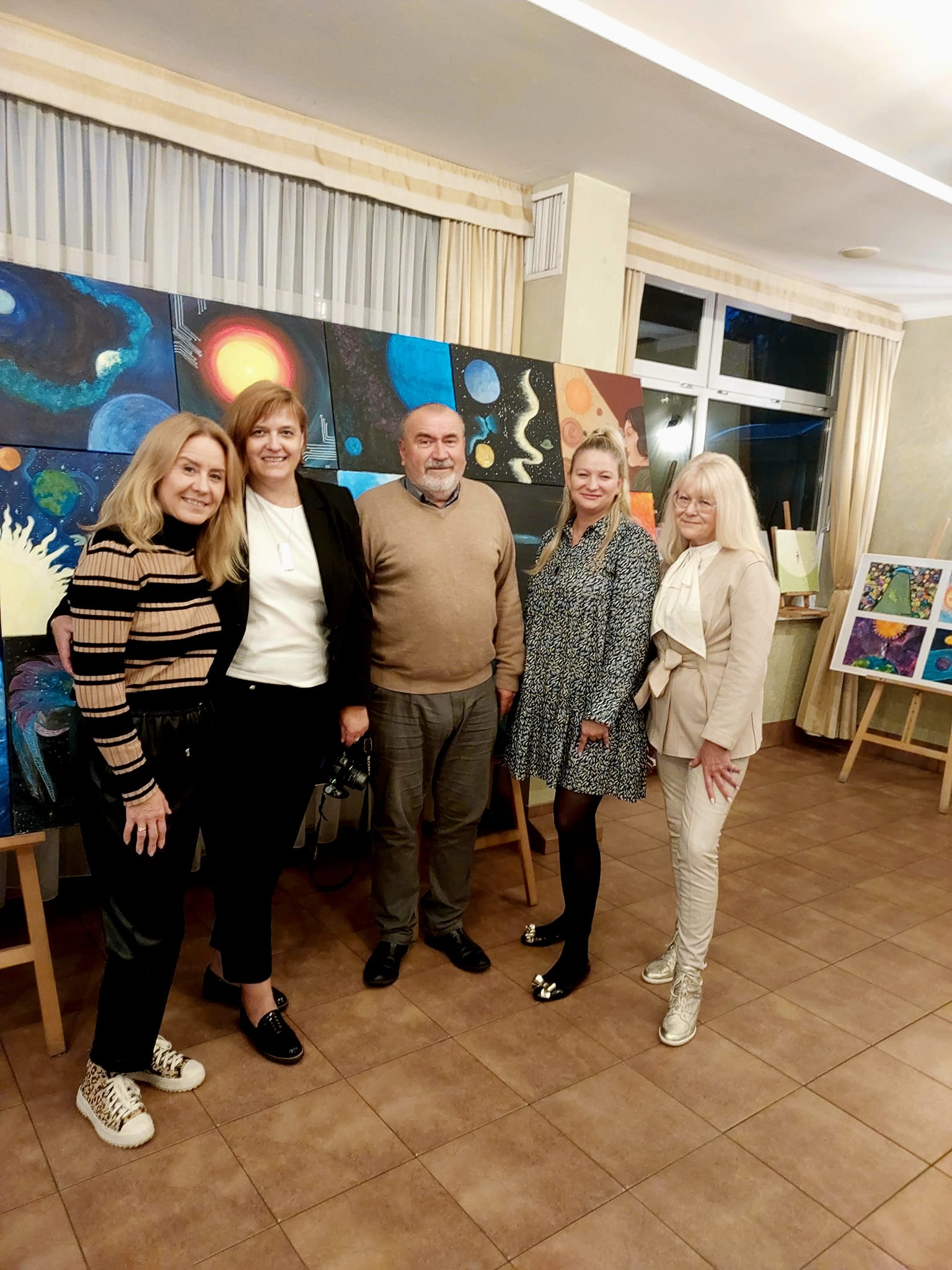 Management and staff of SSM in Olsztyn in the background of the exhibition of works.