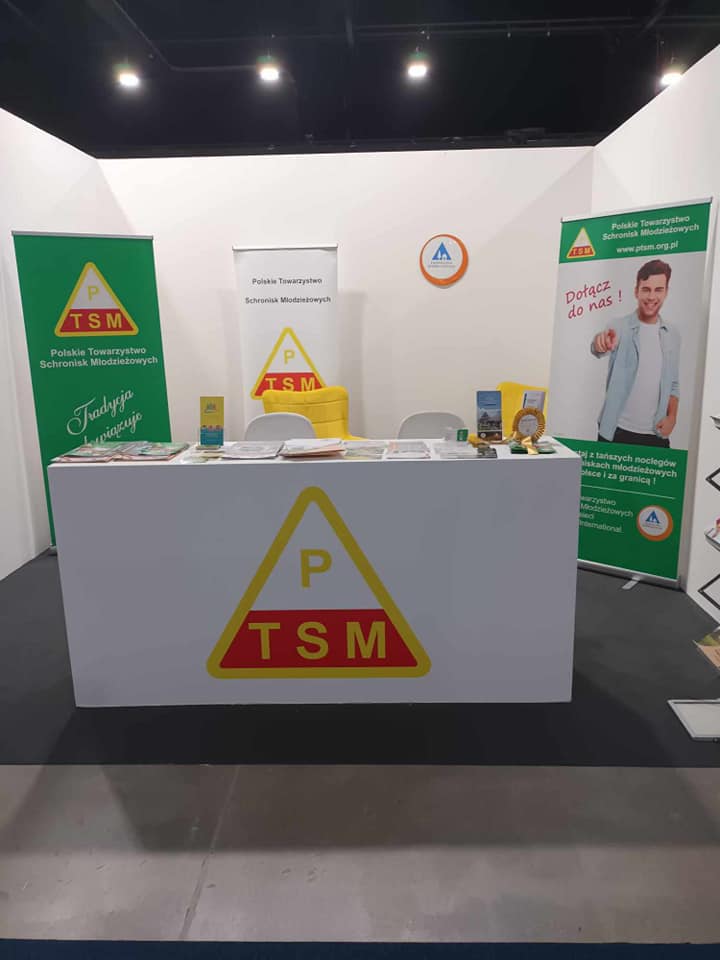 Photo of booth with PTSM advertising banners, flyers and business cards on stand and counter.